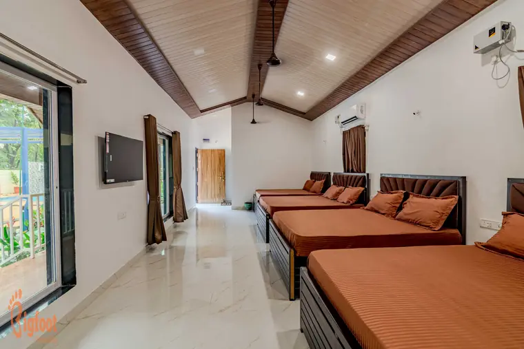 Bedding layout in the dormitory room at JS Farm Resort, Karjat